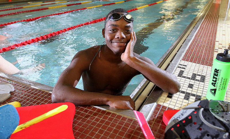 smiling young man in a swimming pool